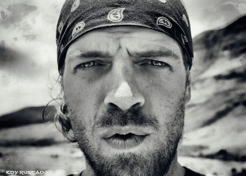 Black and white closeup of a man with a bandana